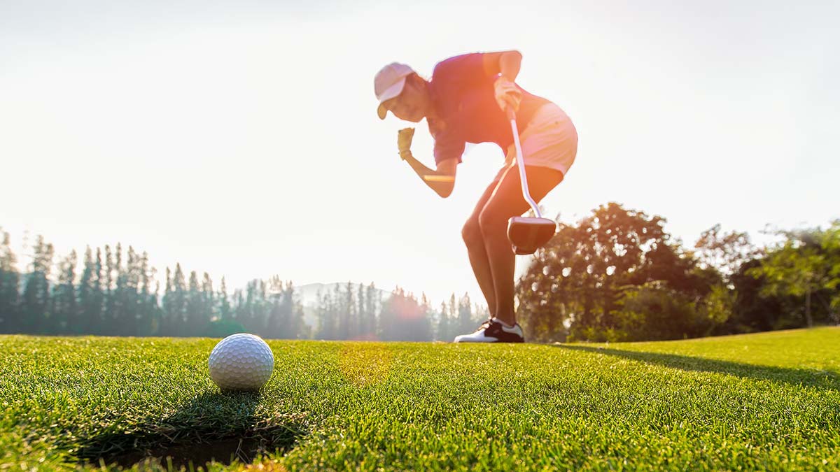 A golfer celebrates a putt—join our Women’s Individual Golf Fun League for moments like this!.